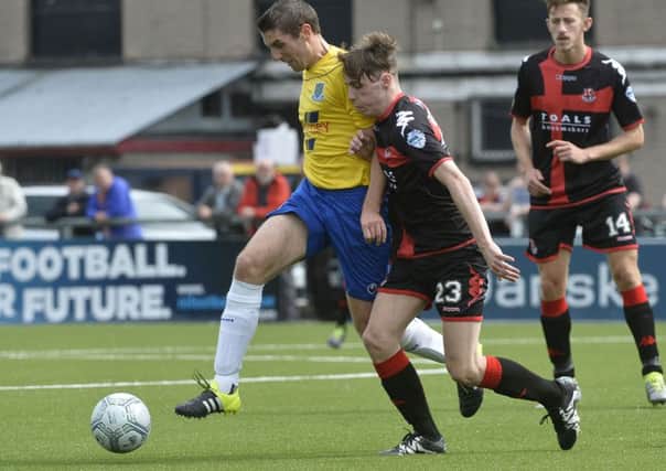 Crusaders Gavin Whyte  in action with Ballymenas Gary Thompson