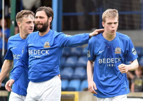 Glenavon manager Gary Hamilton (centre) with two of his side's scorers, Joel Cooper (left) and Rhys Marshall, against Carrick Rangers. Pic by PressEye Ltd.