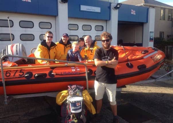 Inspirational fundraiser Alex Ellis-Roswell was in Larne recently as part of his epic mission to walk round the entire coasts of Great Britain and the island of Ireland. He is pictured with Larne RNLI volunteers outside Larne Lifeboat Station. INLT 32-664-CON