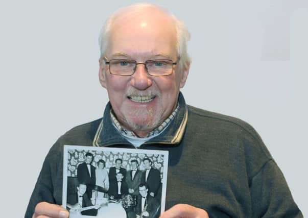 Ernie Singleton pictured with a photograph of The Jimmy Johnston Showband taken in the early 1960s approx.