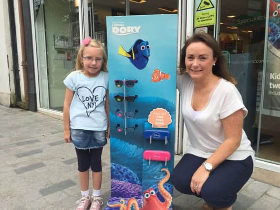 Young Lisburn girl Lily Lilburn (5) won a special Finding Dory competition courtesy of Specsavers and Odyssey Cinemas. Pictured with Lily is Lisburn Specsavers, Bow Street store director Natalie Latham.