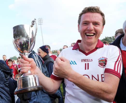 Slaughtneil captain Frank McEldowney receiving the John McLaughlin Trophy from Mickey Lynch, M&L Contracts after last season's final. (Photo Lorcan Doherty / Presseye.com)
