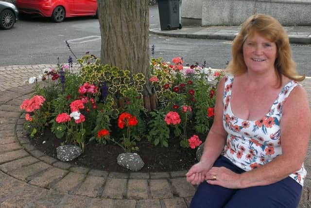 Ann Magee at the spruced-up circle at the bottom of Mill Brae. INLT-33-704-con
