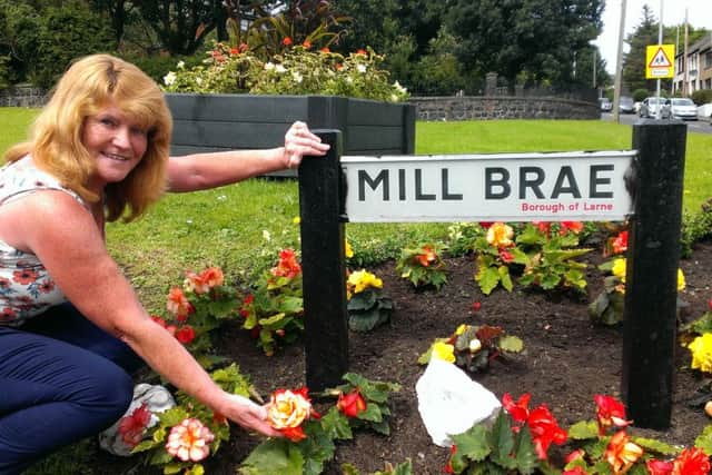 Ann Magee tends her flowers at Mill Brae. INLT-33-701-con