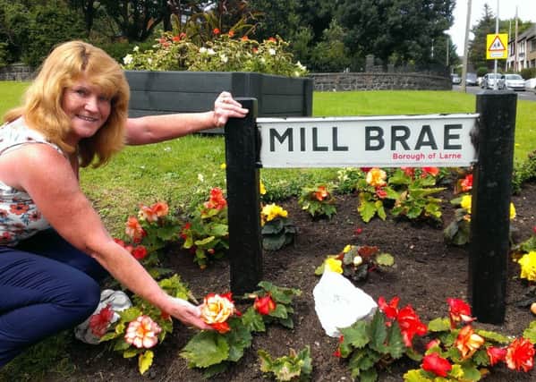 Ann Magee tends her flowers at Mill Brae. INLT-33-701-con