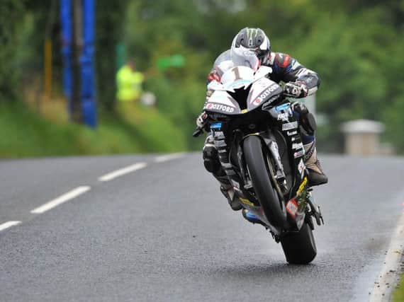 Michael Dunlop has claimed pole position in the Superbike class at the MCE Ulster Grand Prix.
