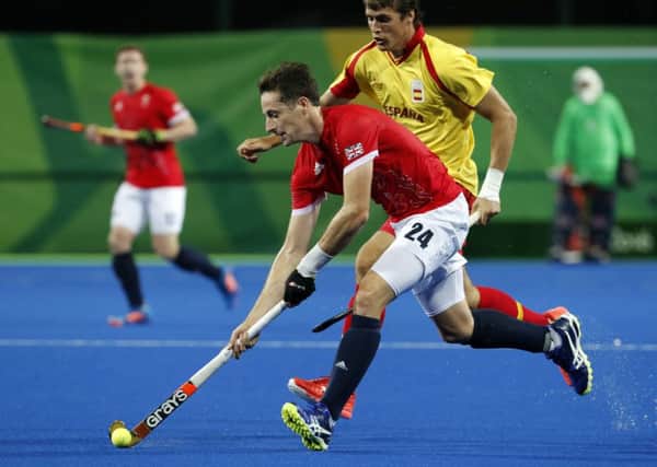 Britain's Iain Lewers, front, fights for the ball with Spain's Alex Casasayas