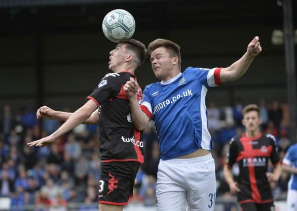 Crusaders winger Gavin Whyte  in action with Linfield's Niall Quinn