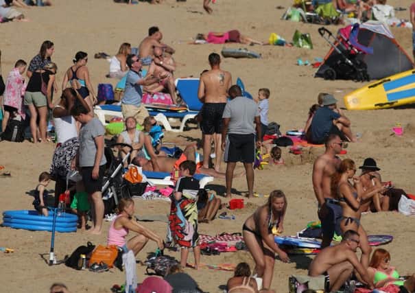 People enjoying a spell of warm weather on the beach at Boscombe in Dorset on Sunday. Photo: Andrew Matthews/PA Wire