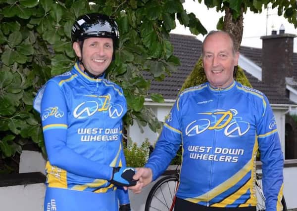 Alistair McCourt, left, winner of the Outlook Shield last Tuesday night on the Castlewellan Road, is congratulated by West Down Wheelers Chairman Billy Maxwell. The Shield goes to the winner of the handicap over two 10 mile TTs.