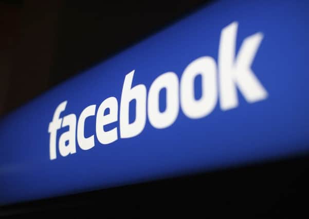 The Facebook logo is pictured at the Facebook headquarters in Menlo Park, California, in this January 29, 2013 file photo. Facebook Inc advertising business grew at its fastest clip since before the company's May initial public offering, helping the company's revenue expand 40 percent to $1.585 billion. REUTERS/Robert Galbraith/Files   (UNITED STATES - Tags: BUSINESS LOGO)