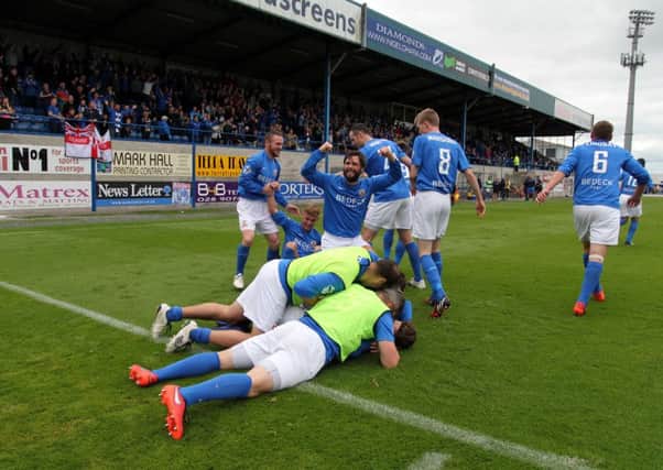 Glenavon player/manager Gary Hamilton celebrates with his team-mates during Saturday's dramatic 3-2 victory over Cliftonville. Pic by Brian Bain.