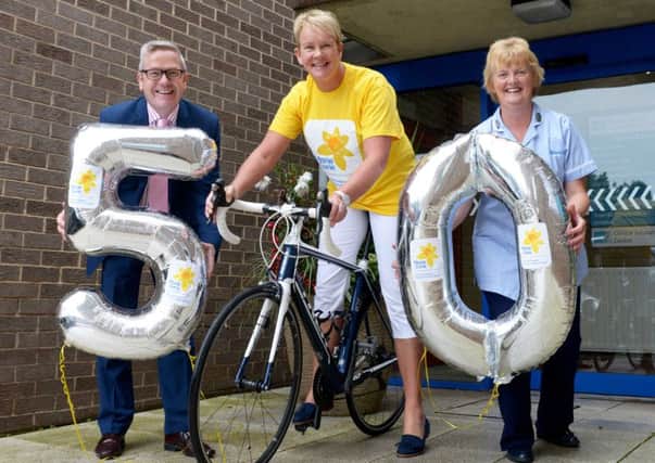 Southern Health and Social Care Chief Executive, Francis Rice, is joined by Marie Curie Nurse, Gladys Brownlee and Anne Hannan from the charitys corporate partnership team to celebrate the success of the organisations charity partnership raising more than Â£50,000.