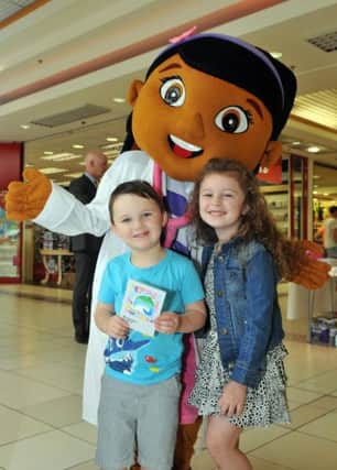 Elliot and Charlotte Reynolds get a copy of the programme for this years Brownlow Festival from childrens TV favorite, Doc McStuffins at the festival launch in Rushmere Centre.