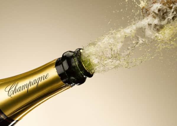 Champagne and cork exploding from bottle
