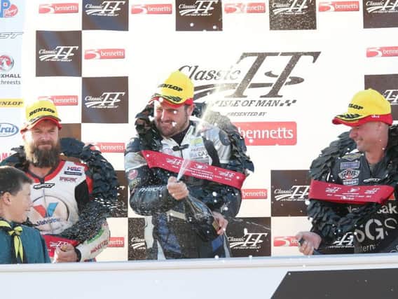 Michael Dunlop celebrates on the podium after winning last year's Formula One race at the Classic TT with runner-up Bruce Anstey (left) and Ryan Farquhar.