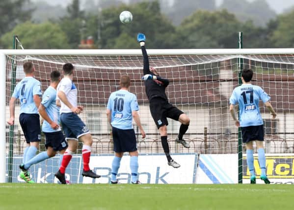 Ross Glendinning gets a hand to the ball during the Ballymena v Ards match