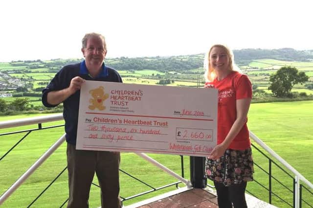 (file photo) Jeremy Jones, Whitehead Golf Club captain, presents Sarah Quinlan from the NI Children's Heartbeat Trust with a cheque for £2,660. The monies were raised from donations by Whitehead Golf Club members to the Captain's Charity. INCT 29-724-CON