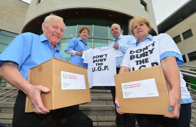 Ulster Grand Prix Supporters Club members Des Stewart, Vanda Robinson, Alderman James Tinsley and Gail Bailie deliver the objection letters to the council.