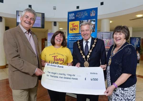 The Chairman of Lisburn & Castlereagh City Councils Leisure and Community Development Committee, Councillor Tim Morrow presenting a cheque for Â£6,500 to local charity Tinylife.