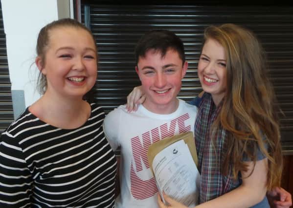 Ashleigh, Megan and David celebrate on GCSE results day at Larne Grammar School.  INLT 35-651-CON