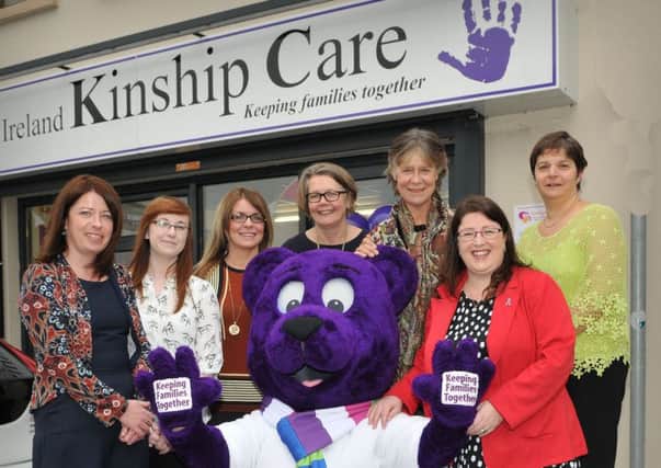 Cuddles the bear with invited guests at the official opening of  Kinship Care at Rainey Street Magherafelt on Monday of this week.INMM4515-377