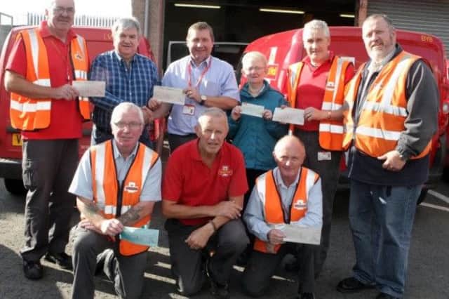 POSTEMEN DELIVER. Manager Ian Dunseith along with local postmen pictured last year handing over six cheques totalling Â£3,206 to Mervyn Ferris and Dorothy Hill from Cancer Research UK. The money was raised through the annual Van Pull and other events.INBM43-15 012SC.