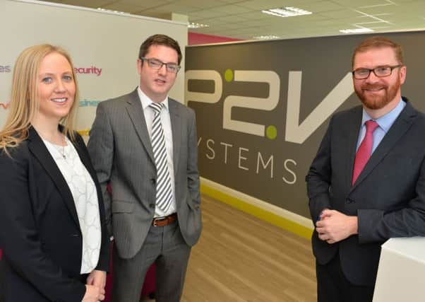 Economy minister Simon Hamilton, right, welcomes P2V's growth plans with its managing director Stephen McCann and marketing director Jackie Wilson.
Photo by Aaron McCracken/Harrisons