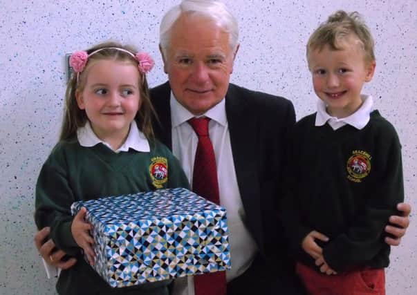 Mr. Lexie Scott receives farewell gifts from pupils