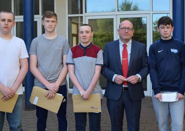 Mr Friel pictured with students at Edmund Rice College on GCSE results day. INNT 35-828CON