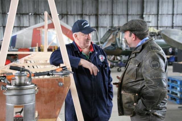 Steve Lowry, left, and BBC television presenter Dick Strawbridge, during an assembly phase of the replica aircraft last spring., in the hangar of the Ulster Aviation Society, Maze/Long Kesh. INUS Lowry and Strawbridge.