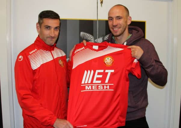 Portadown club captain Keith O'Hara (left) offers Alan Byrne a warm welcome to Shamrock Park.