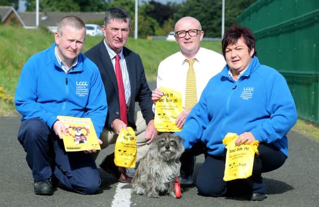Promoting the pilot 'Big Scoop Campaign' in the Laurelhill area are: Marty O'Boyle, Enforcement Officer; Councillor James Baird, Chairman of the Council's Environmental Services Committee; Ronnie Milsop, Regional Campaign Manager, Dogs Trust; Joanne MacAskill, Senior Enforcement Officer and Mitzi who is owned by Bertie McLaughlin.