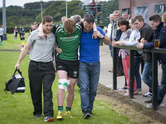 City of Derry debutant Callum O'Hagan gets helped from the field just before half time in last week's game against Ballymena at Judges Road. DER3416MC003