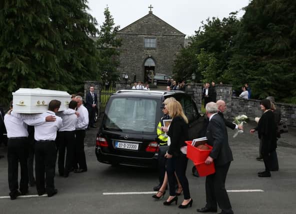 One of the children's coffins is taken into Saint Mary's Church in Castlerahan, Co Cavan