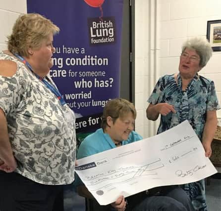 Betty Calvert, Coleraine , presenting a cheque for Â£660, the proceeds of a BBQ, to Breathe Easy Chairperson Margaret Henry.