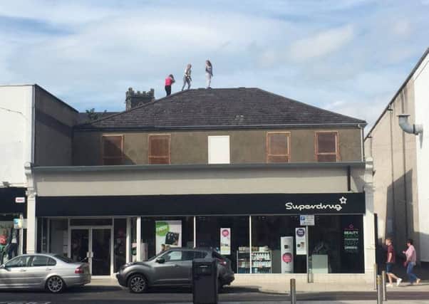 Youngsters on a roof top in Larne on Tuesday August 30. INLT-36-713-con