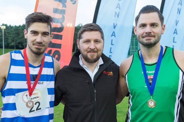 David Veck of firmus energy at Meet 6 of the firmus energy 2016 Super Six series are Aaron Carlisle (right) of Derry Track Club and Ryan Henry (left) of Willowfield Temperance Harriers, who came first and second respectively in the senior mens 200 metre event.