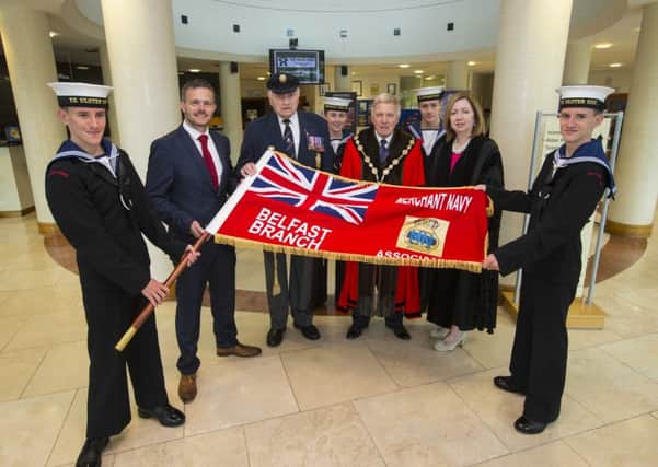Representatives of Lisburn Sea Cadets are pictured with the Merchant Navy Association's Flag alongside (l-r) Robbie Butler MLA; Mr John Coulter, Chairman of the Merchant Navy Association; the Mayor, Councillor Brian Bloomfield MBE and Dr Theresa Donaldson, Chief Executive.