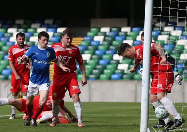 Adam Rodgers attempts to block Mark Stafford's header - with the match officials ruling the ball eventually crossed the line for Linfield's second goal against Portadown. Pic by PressEye Ltd.