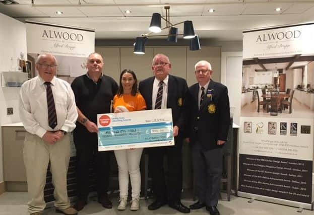 Joanne Wilson (Meningitis Now) collecting a cheque for £700 from Wilson Briggs and Colin Wilson of M/S Alfred Briggs (Alwood) Ltd following this year's annual inter-club invitation rinks competition for the Alwood Shield. Also included are Alwood Shield competition organisers, from left, Alan Briggs and Melvyn Hamilton.