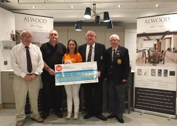 Joanne Wilson (Meningitis Now) collecting a cheque for Â£700 from Wilson Briggs and Colin Wilson of M/S Alfred Briggs (Alwood) Ltd following this year's annual inter-club invitation rinks competition for the Alwood Shield. Also included are Alwood Shield competition organisers, from left, Alan Briggs and Melvyn Hamilton.
