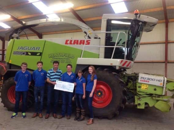 Members pictured receiving the cheque for over Â£1000 from UFU member Mr M Gordon.