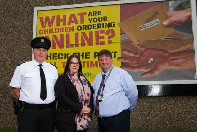 PSNI Chief Inspector Ian Magee, PCSP vice-chair Leanne Abernethy and Sergeant Terry McKenna at Coleraine's Long Commons car park billboard poster. INCR 40-707-CON