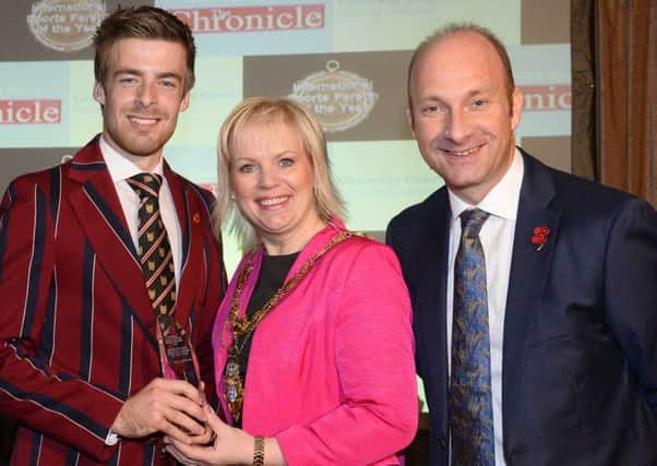 Winner of the International Sports Person of the Yearin 2015, GB rower, Joel Cassells, being presented with his award by the then Mayor of Causeway Coast and Glens Borough Council, Councillor Michelle Knight McQuillan, with compere for the  evening Stephen Watson.