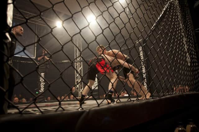Keith O'Rulligan and Gracjen Drezwski lock horns during the 66kg fight at Saturday night's MMA Real Fighting Championship at the Foyle Arena. DER3816MC029