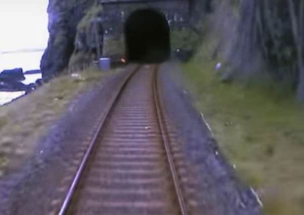 A lifeguard alerts the train driver to the danger ahead after two people wandered into Downhill tunnel. INLS 40-790-CON