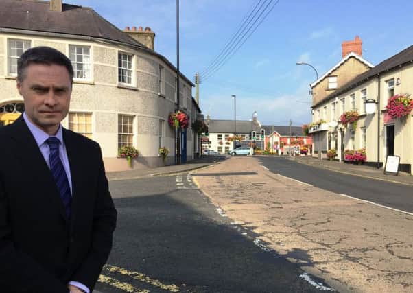 MLA Paul Frew in the village of Ahoghill where overhead power lines have been a source of annoyance due to perching birds.