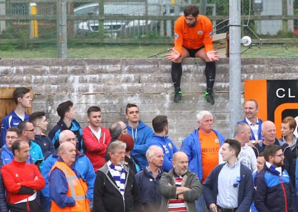 Glenavon player/manager Gary Hamilton talking with fans from a special vantage point following his red card on Saturday against Dungannon Swifts. Pic by Simon Graham.
