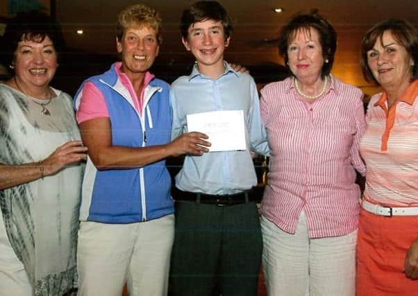 World junior golf champion Tom McKibbin (13), from Newtownabbey, who presented the Ladies Prize at the NI Children's Hospice charity day at Forwilliam Golf Club which raised over Â£6,000.  From left Maureen Shields, Mairead Craig, Alacaoque Logan and Josephine McKenna. INNT 39-835CON